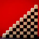 white and black checkered brick toys stacked on top of each other forming ladder